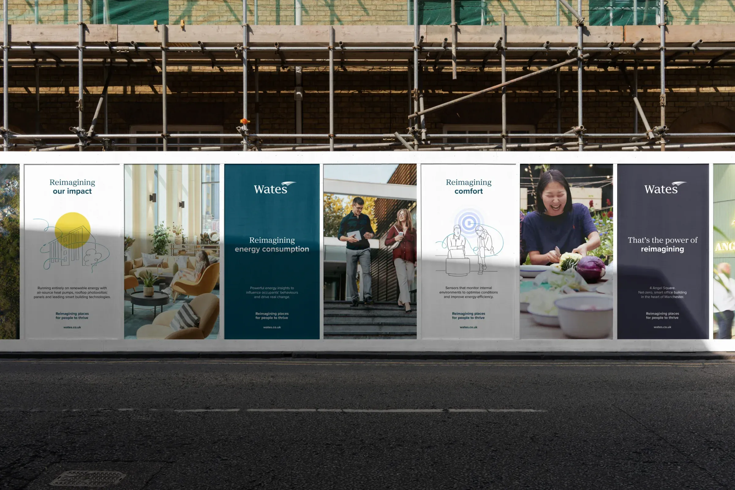 Wates hoarding along a street, with posters reading Reimagining our impact, Reimagining energy consumption and Reimagining comfort